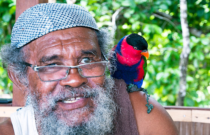 Pak Martin Makusi and friendly lory at Pulau Kri, Raja Ampat
